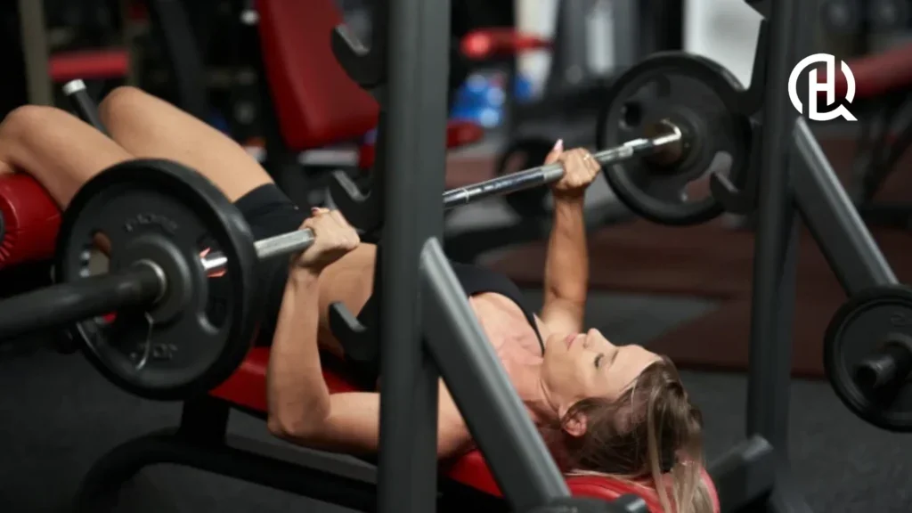 Girl in gym clothes doing decline barbell bench press