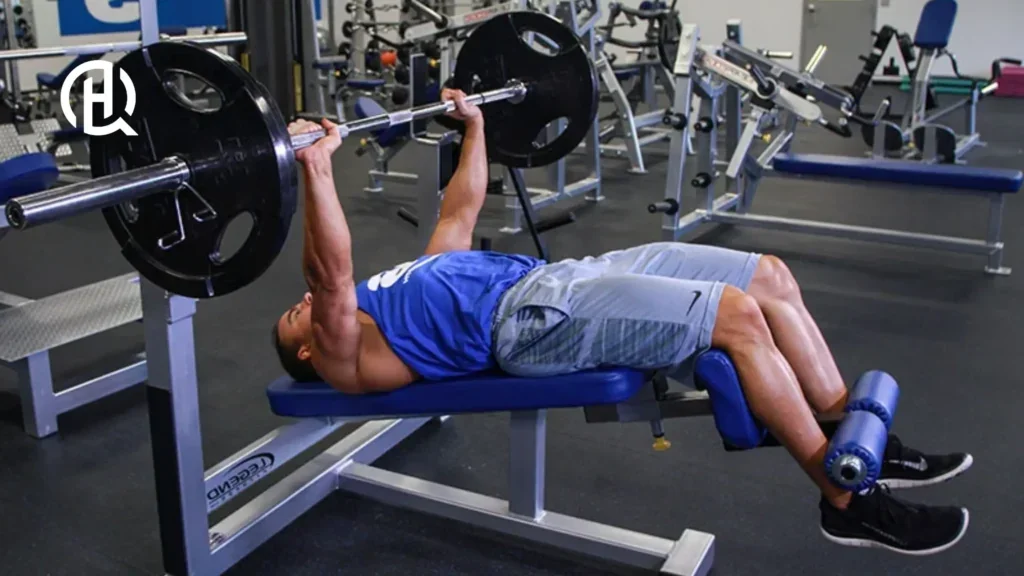 Man in blue tank top doing a chest exercise