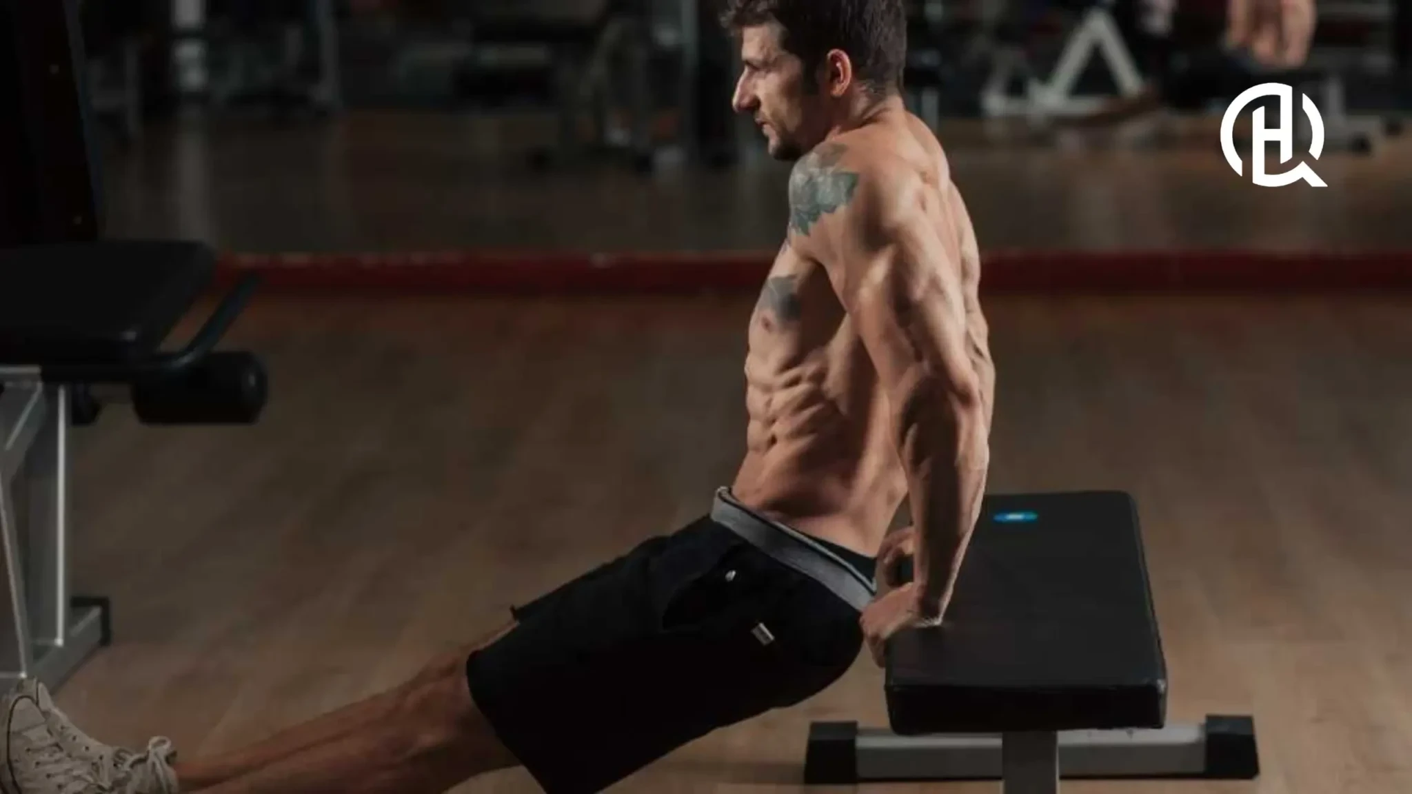 Man doing Bench Dips without shirt, showing muscles