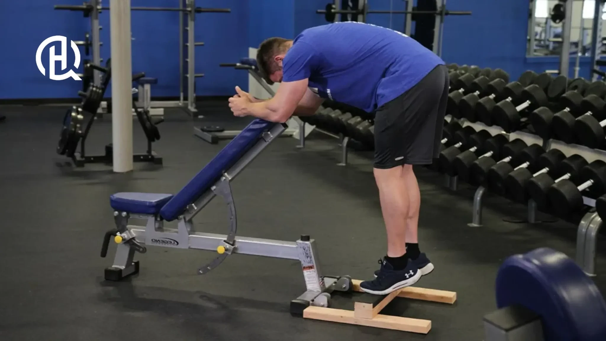 A person leaning on the bench while doing a calf raise