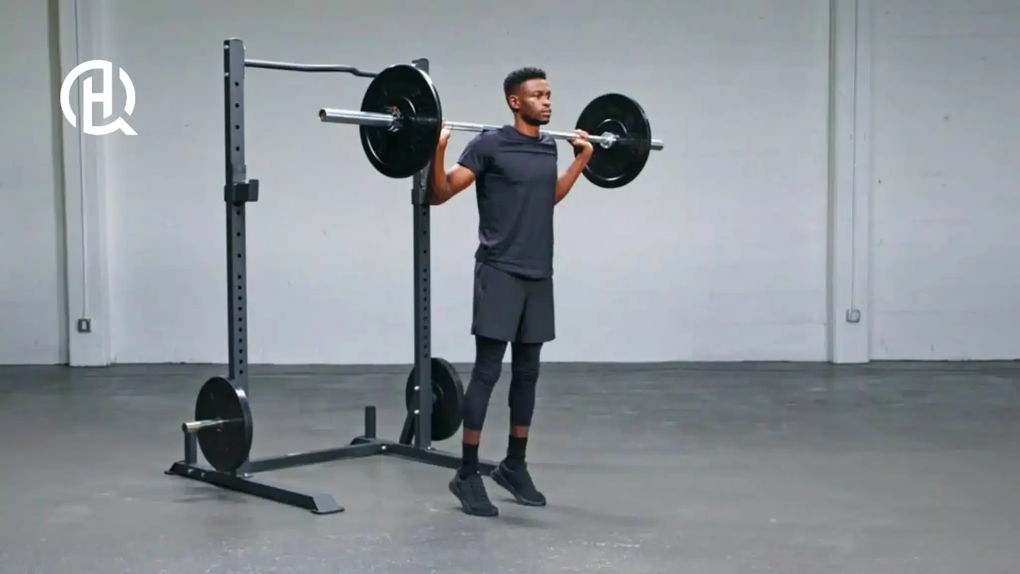 A man doing standing calf raise with a barbell