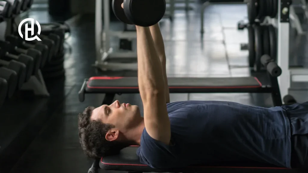 Guy doing barbell bench press in a gym