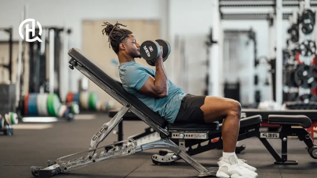 An image of a gym, the person are doing curls as he is leaning backwards for that extra stretch
