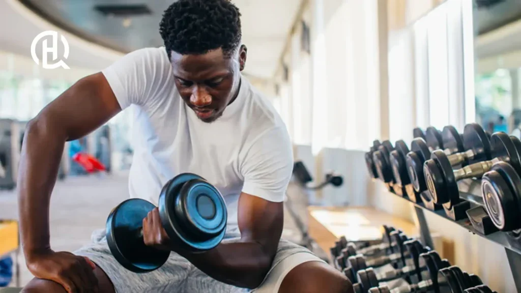 Man doing concentration curls, facing the camera