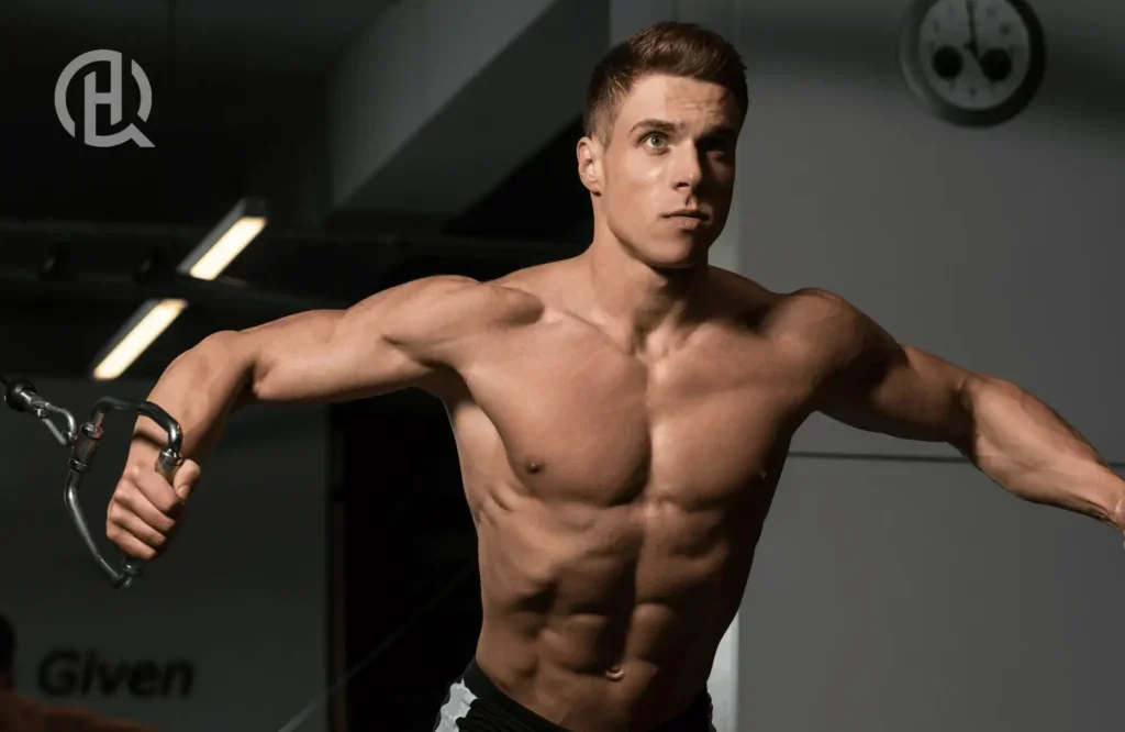 A guy working out using the cable crossover machine