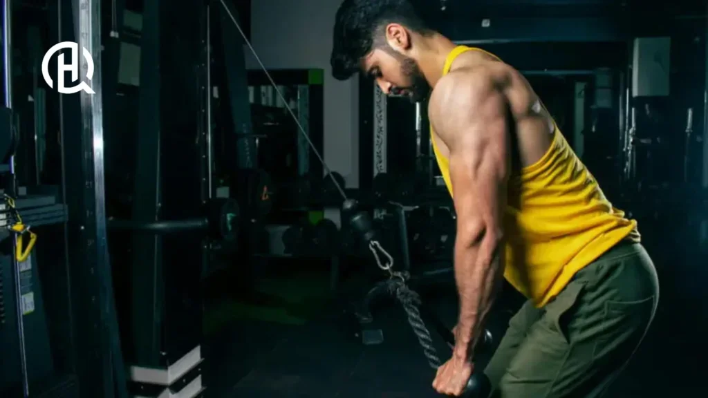 Man in yellow sando doing Cable rope pushdown