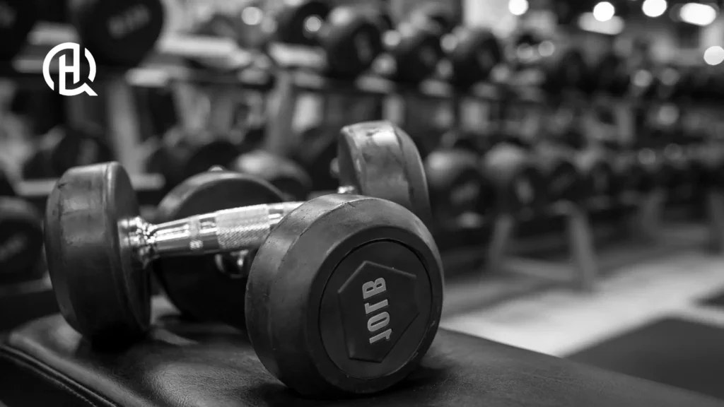 Dumbbells on Bench – Close-up of heavy dumbbells in a gym, symbolizing strength training