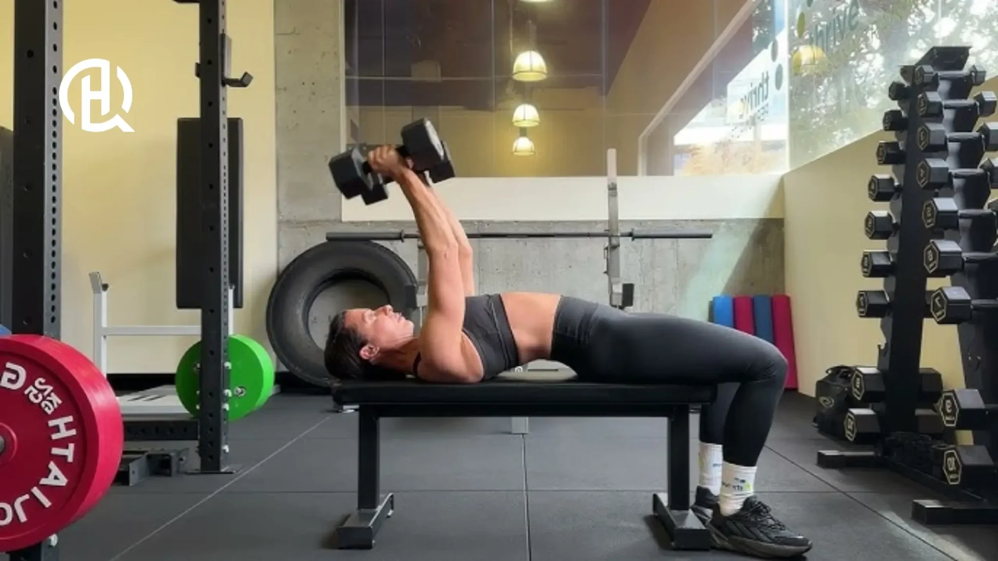 Woman demonstrating proper elbow position during lying triceps extension