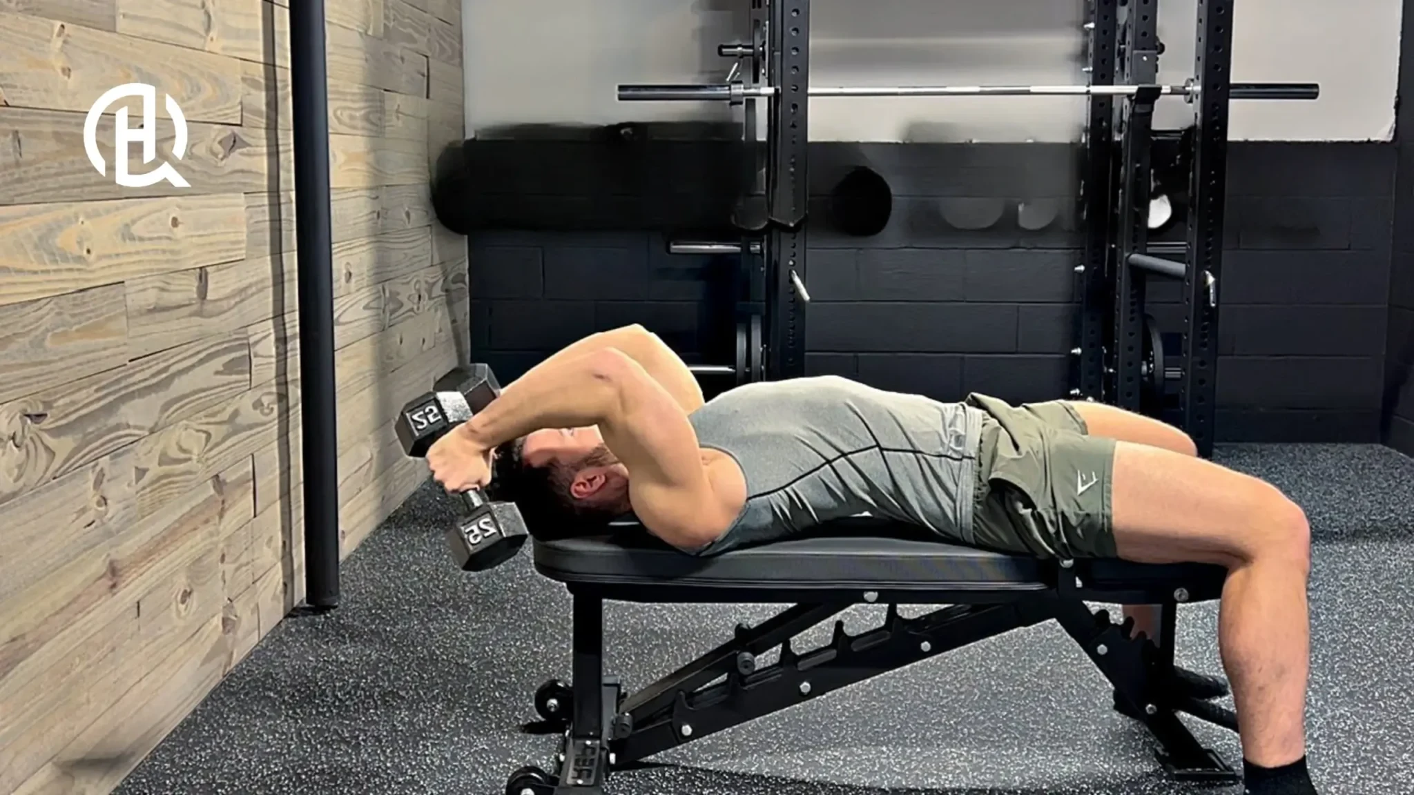 Man lying on a bench training arms