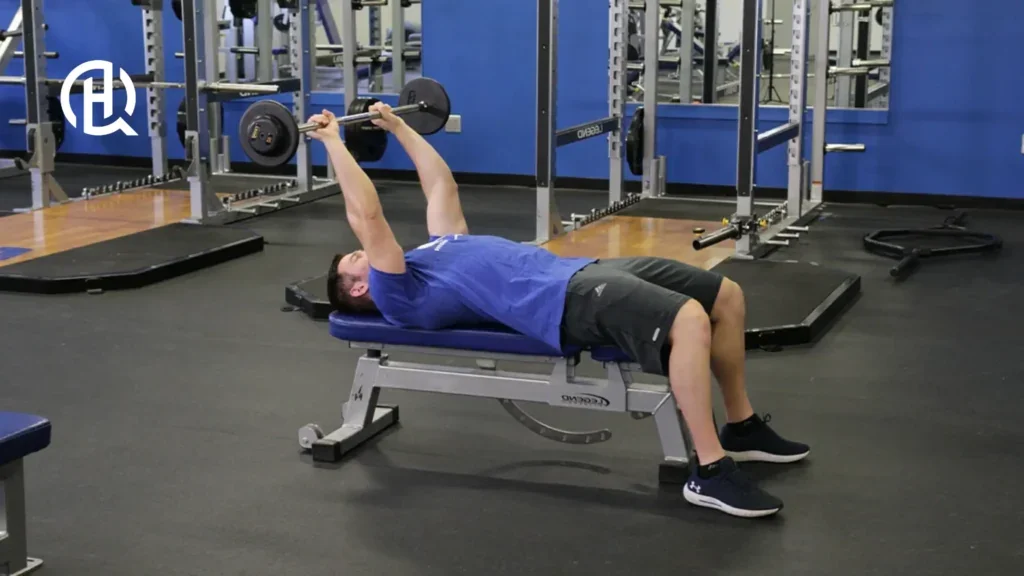 Man in blue shirt doing Lying Triceps Extension