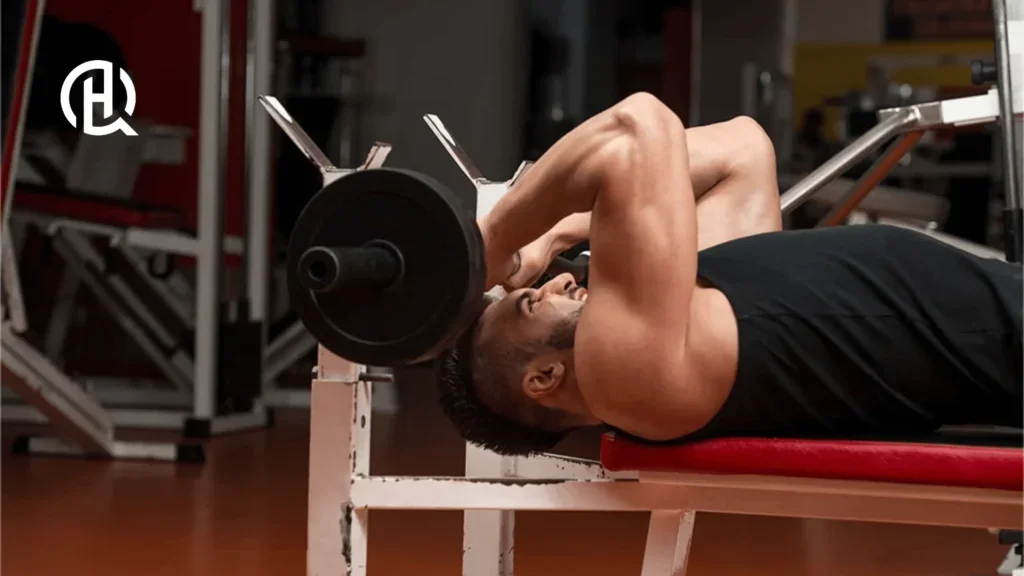 Man in black sando doing Lying Triceps Extension