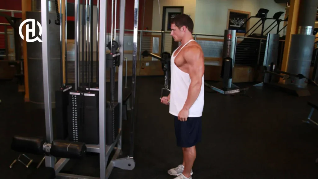 Man in white shirt training arms in the gym