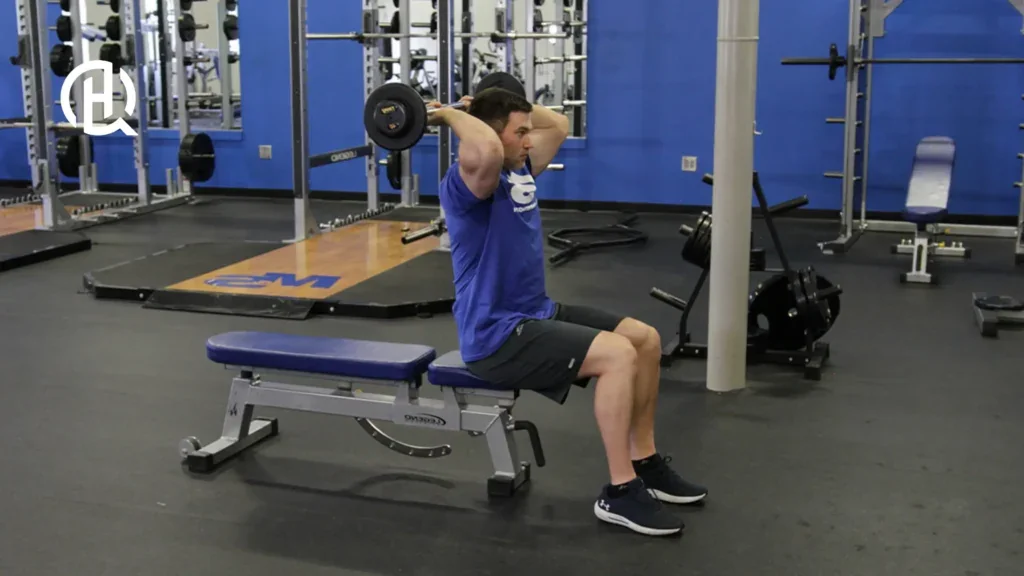 A person demonstrating the barbell french press