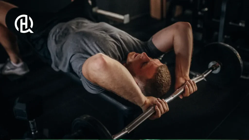 A person is lying on the bench whilst doing Tricep Exercises