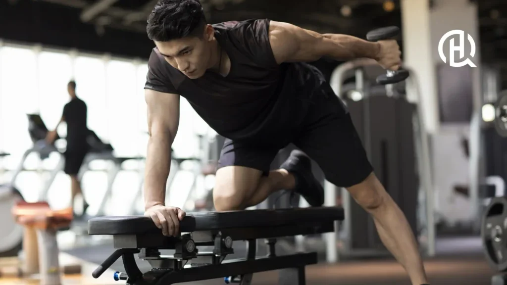 An asian man wearing black clothes doing Tricep Kickback