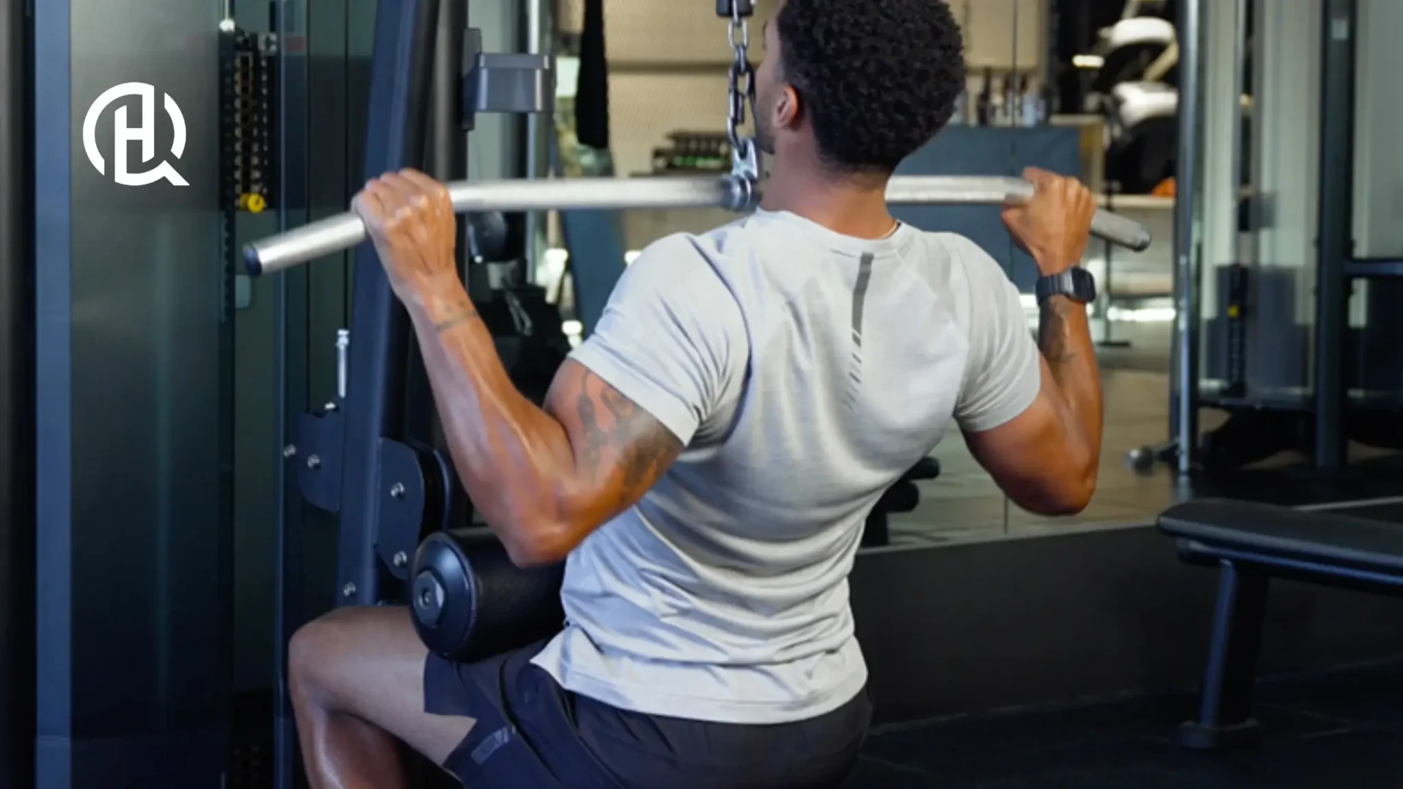 Young man performing wide-grip pulldowns with proper grip width